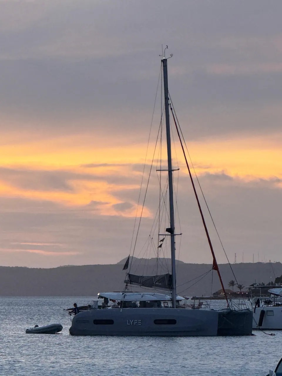 Our sailing catamaran LYFE at anchor at sunset